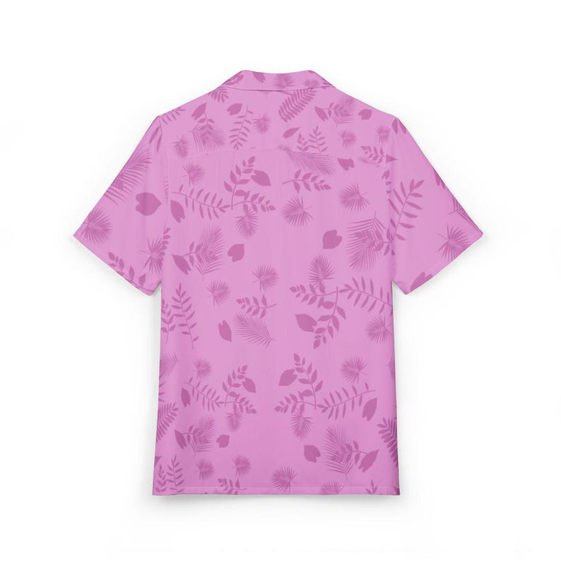 May include: A short-sleeved button-down shirt in a light pink hue, adorned with a repeating pattern of stylized leaves and botanical elements in a slightly darker shade of pink. The shirt has a classic collar and a relaxed fit, suitable for casual wear.
