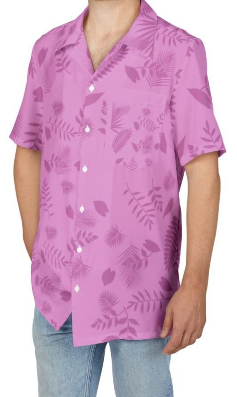 May include: A short-sleeved, button-down shirt in a light purple hue, adorned with a repeating pattern of darker purple tropical leaves and foliage. The shirt features a classic collar, a chest pocket, and white buttons.