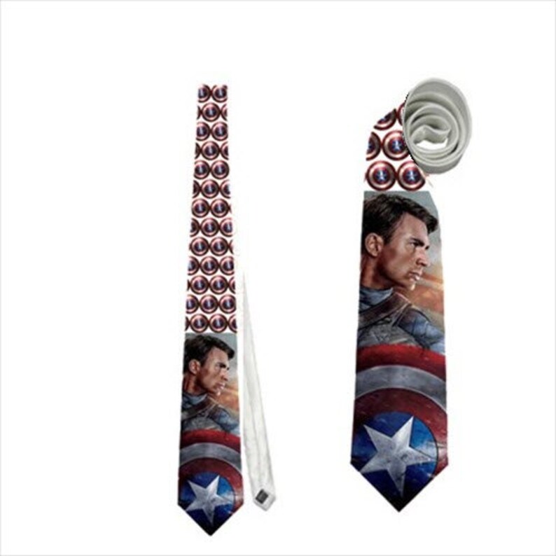 May include: A Captain America themed necktie. The tie features a repeating pattern of Captain America's shield and a portrait of Captain America. The tie is blue, red, white, and silver.
