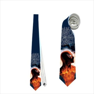 May include: A navy blue necktie featuring a Spider-Man design. The tie displays a silhouette of Spider-Man, a spider web, and the Spider-Man logo. The tie is made of a smooth fabric and has a white backing.
