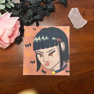 May include: A digital illustration of a woman with black hair and bangs. She has orange eyes and is wearing a black choker with a gold charm. The background is orange with black bats.