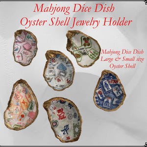May include: Oyster shell jewelry holders with gold trim, featuring Mahjong tile designs. The shells are in various colors, including pink, blue, and white. Text on the image reads "Mahjong Dice Dish Oyster Shell Jewelry Holder."