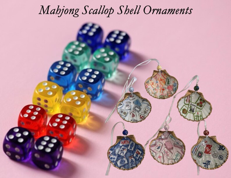 May include: A collection of colorful dice and six seashell ornaments. The dice are in various colors, including blue, green, yellow, red, and purple. The seashell ornaments have Mahjong-themed designs and are strung on a wire.