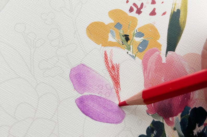 May include: A red colored pencil is used to color a floral illustration on textured white paper. The drawing features a yellow flower, a pink flower, and a purple petal, with additional faint gray outlines of uncolored floral stems and leaves.