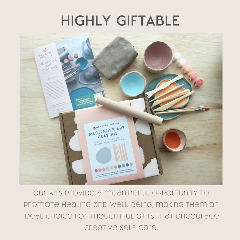 May include: A meditative art clay kit in a pink and white box with a light brown rolling pin, a small bowl of orange clay, and a pamphlet with the words "Breathe People Meditative Art Clay Kits".