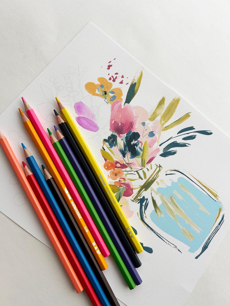 May include: A set of colored pencils in shades of orange, blue, yellow, green, purple, and black arranged diagonally next to a white paper featuring a partially painted floral arrangement in a vase with pink, yellow, and blue brushstrokes.