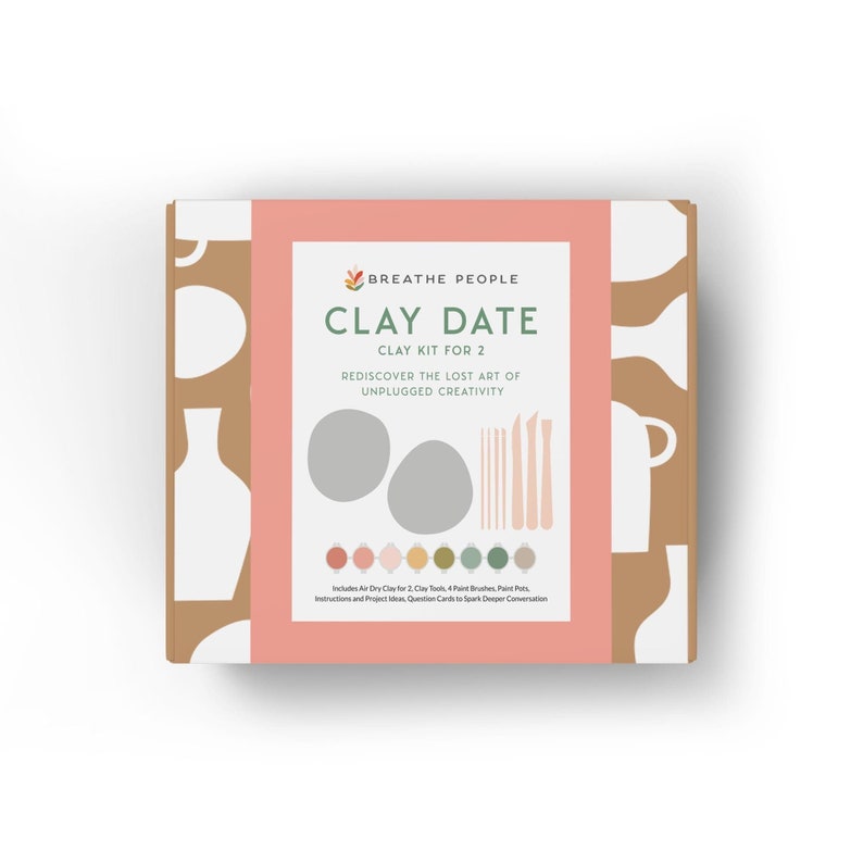 May include: A pink and brown box with the text "BREATHE PEOPLE CLAY DATE CLAY KIT FOR 2 REDISCOVER THE LOST ART OF UNPLUGGED CREATIVITY" and an illustration of two clay circles, tools, and paint pots.