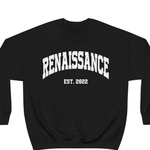 May include: Black sweatshirt with white text that reads "RENAISSANCE EST. 2022" in an arched font.