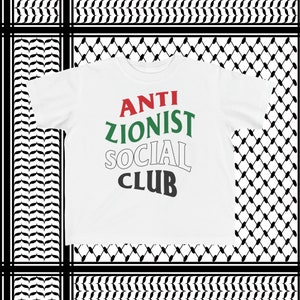 May include: White t-shirt with the text "ANTI ZIONIST SOCIAL CLUB" in green, red, and black letters.