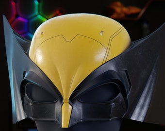 May include: A yellow and black Wolverine mask, displayed on a black mannequin head. The mask features a yellow top with black accents and large, pointed black ear-like extensions. The mask is a replica of the character's mask.