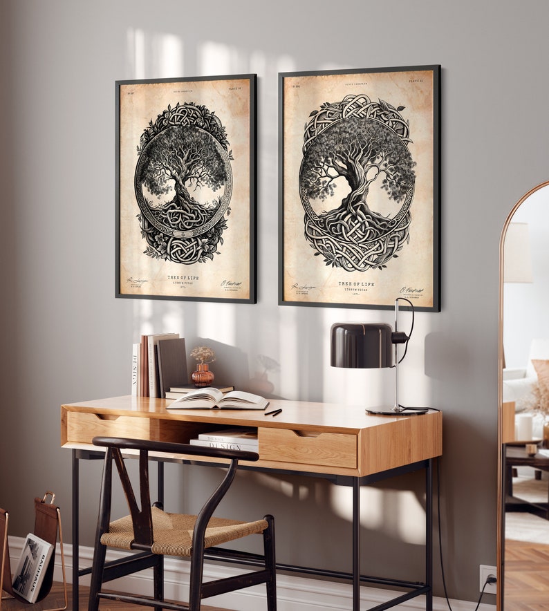 May include: Two black framed prints of a tree of life design with intricate knotwork and a vintage background. The prints are hanging on a gray wall above a wooden desk with a black chair.