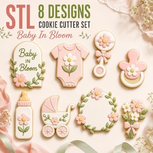 May include: A set of 8 cookie cutters featuring baby-themed shapes including a onesie, rattle, pacifier, baby bottle, carriage, and floral accents. The text "STL 8 DESIGNS COOKIE CUTTER SET Baby In Bloom" is printed at the top of the image.