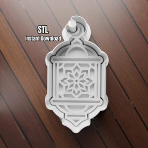May include: A white plastic cookie cutter in the shape of a lantern with a floral design in the center. The text "STL Instant Download" is printed on the image. The cutter is on a wooden surface.