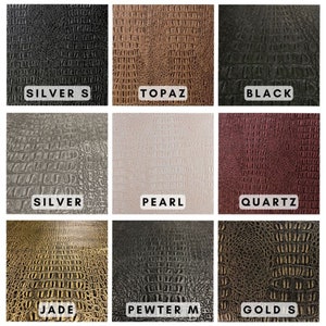 K&ouml;nnte beinhalten: Neun verschiedene Farbmuster aus Kunstleder mit Kroko-Pr&auml;gung. Die Farben sind Silber S, Topas, Schwarz, Silber, Perl, Quarz, Jade, Zinn M und Gold S.