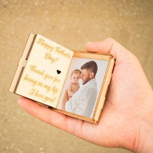 Music box of bright wood with the text Happy Father's day and the picture of dad and baby