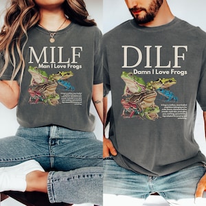 May include: Two gray t-shirts with frog graphics. One shirt reads "MILF Man I Love Frogs" and the other reads "DILF Damn I Love Frogs". The frog graphic features various colorful frogs.
