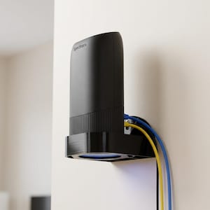 May include: A black Spectrum modem mounted on a white wall. The modem is cylindrical with the Spectrum logo and has a ridged lower section. Blue and yellow cables are connected to the modem.