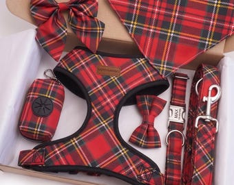 May include: A pet accessory set featuring a red, black, and yellow plaid pattern. The set includes a harness with a HappyFurPaws label, a triangular bandana, a large bow, a small bow, a waste bag dispenser, a collar with a tag reading MAX, and a leash.