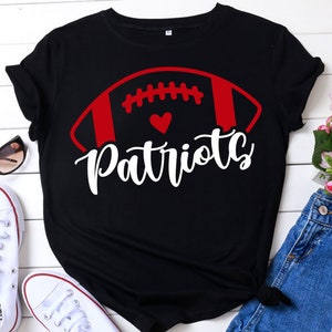 May include: Black t-shirt with a red and white football graphic and the word "Patriots" in white lettering.