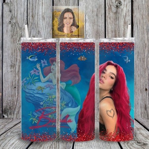 May include: Three stainless steel tumblers with a red glitter finish. The tumblers feature a blue background with a mermaid, a fish, and a woman with red hair. The tumblers are personalized with the name "Brianda".
