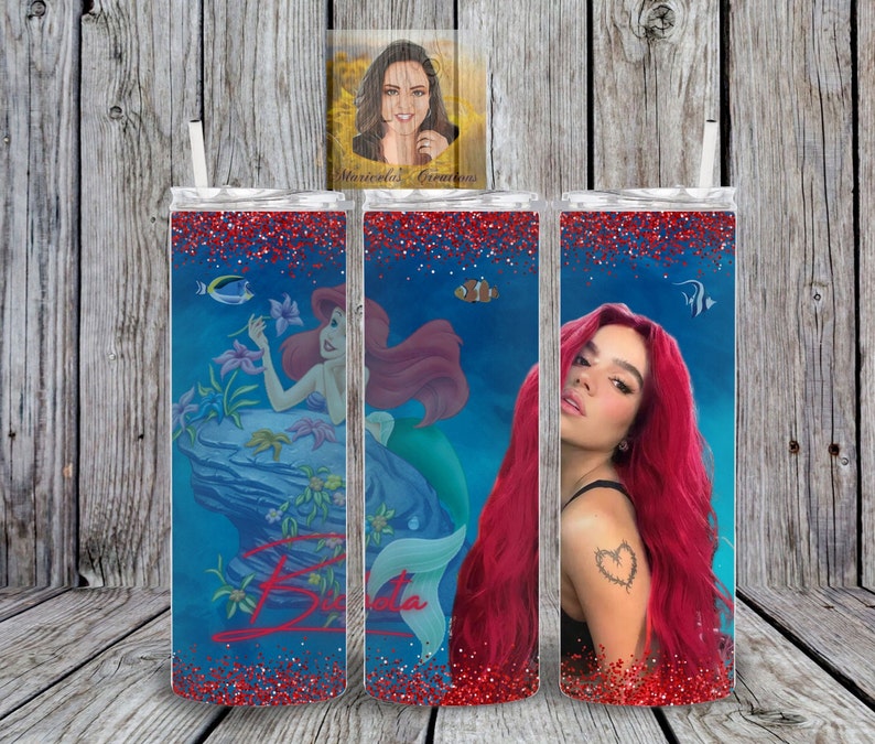 May include: Three stainless steel tumblers with a red glitter finish. The tumblers feature a blue background with a mermaid, a fish, and a woman with red hair. The tumblers are personalized with the name "Brianda".