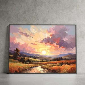 May include: Framed landscape painting depicting a sunset over a valley. The artwork features a vibrant sky with pink, orange, and purple hues. A river flows through the foreground, with fields and hills in the distance.