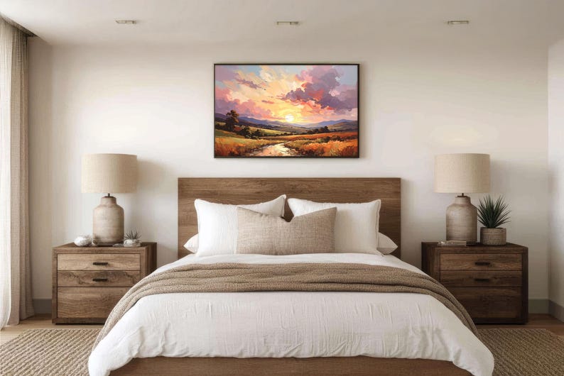 May include: A bedroom scene featuring a bed with a wooden headboard, white bedding, and a brown throw blanket. Two wooden nightstands flank the bed, each with a lamp and decorative items. A landscape painting hangs above the bed.