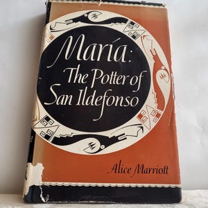 May include: Vintage book titled "Maria: The Potter of San Ildefonso" by Alice Marriott. The cover features a black oval with white text and a decorative border on an orange background. The book shows signs of wear.