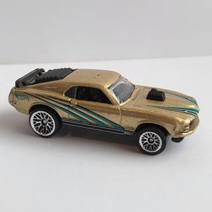 VINTAGE 1997 Hot Wheels Gold Ford Mustang Mach 1 Diecast Toy Car/Aqua & Black lines design on sides and hood/Spoiler/Collectible/Malaysia