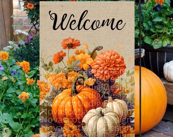 May include: A burlap welcome sign with a fall theme. The sign features a bouquet of orange and yellow flowers, pumpkins, and gourds. The text "Welcome" is printed in black cursive font.