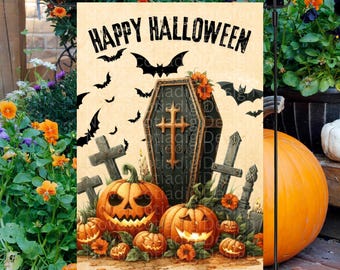 May include: A Halloween garden flag with a black coffin with a cross on it, surrounded by jack-o'-lanterns and bats. The flag reads "Happy Halloween".