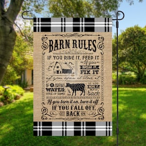 May include: A burlap garden flag with black and white plaid trim. The flag features a set of rules for a barn, written in black text. The text reads: "Barn Rules. If you ride it, feed it. If you break it, fix it. If you open it, close it. If it drinks water, give it some. If you move it, put it back. If you turn it on, turn it off. If you fall off, get back on."