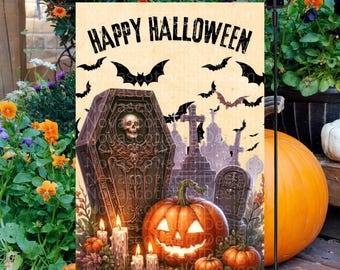 May include: A Halloween-themed garden flag with the text "Happy Halloween" in black lettering. The flag features a spooky graveyard scene with a coffin, tombstones, and a jack-o'-lantern.