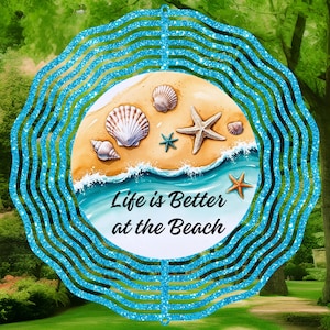 May include: A blue and white wind spinner featuring a beach scene with the text "Life is Better at the Beach".