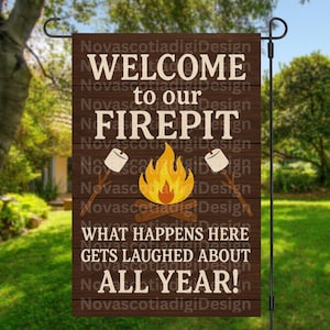 May include: A brown wooden garden flag with the text "WELCOME to our FIREPIT" in white. The flag features a campfire graphic with marshmallows on sticks. The text "WHAT HAPPENS HERE GETS LAUGHED ABOUT ALL YEAR!" is also displayed.