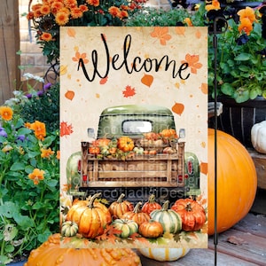 May include: A green vintage truck bed filled with pumpkins and fall leaves. The truck is on a beige background with the word "Welcome" in black script.  The truck is surrounded by pumpkins on the bottom of the image.