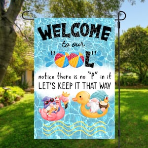 May include: A blue and white welcome sign with a pool theme. It says "Welcome to our "P"ol" notice there is no "P" in it LET'S KEEP IT THAT WAY". There are two gnomes in the pool, one on a pink flamingo and one on a yellow duck.