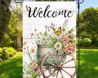 May include: A white wooden sign with the word "Welcome" in black script. A vintage wagon wheel with a green wooden base is filled with a bouquet of white and pink flowers and a yellow butterfly.