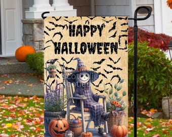 May include: A Halloween garden flag with a black and white illustration of a skeleton wearing a witch hat and sitting in a rocking chair. The flag has a background of bats and the text "Happy Halloween".