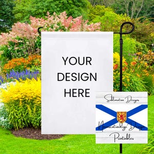 May include: A white garden flag with the text "YOUR DESIGN HERE" on it. The flag is attached to a black metal pole and is in front of a green lawn with colorful flowers.
