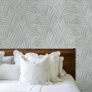 tropical boho palm leaf wallpaper in soft calm blue and white shown in removable peel and stick or prepasted. Perfect for modern coastal bathroom, powder room, nursery or laundry room accent wall.