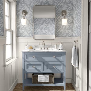 tropical boho palm leaf wallpaper in soft calm blue and white shown in removable peel and stick or prepasted. Perfect for modern coastal bathroom, powder room, nursery or laundry room accent wall.