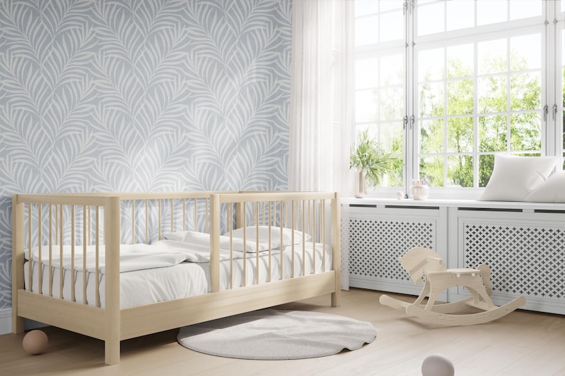tropical boho palm leaf wallpaper in soft calm blue and white shown in removable peel and stick or prepasted. Perfect for modern coastal bathroom, powder room, nursery or laundry room accent wall.
