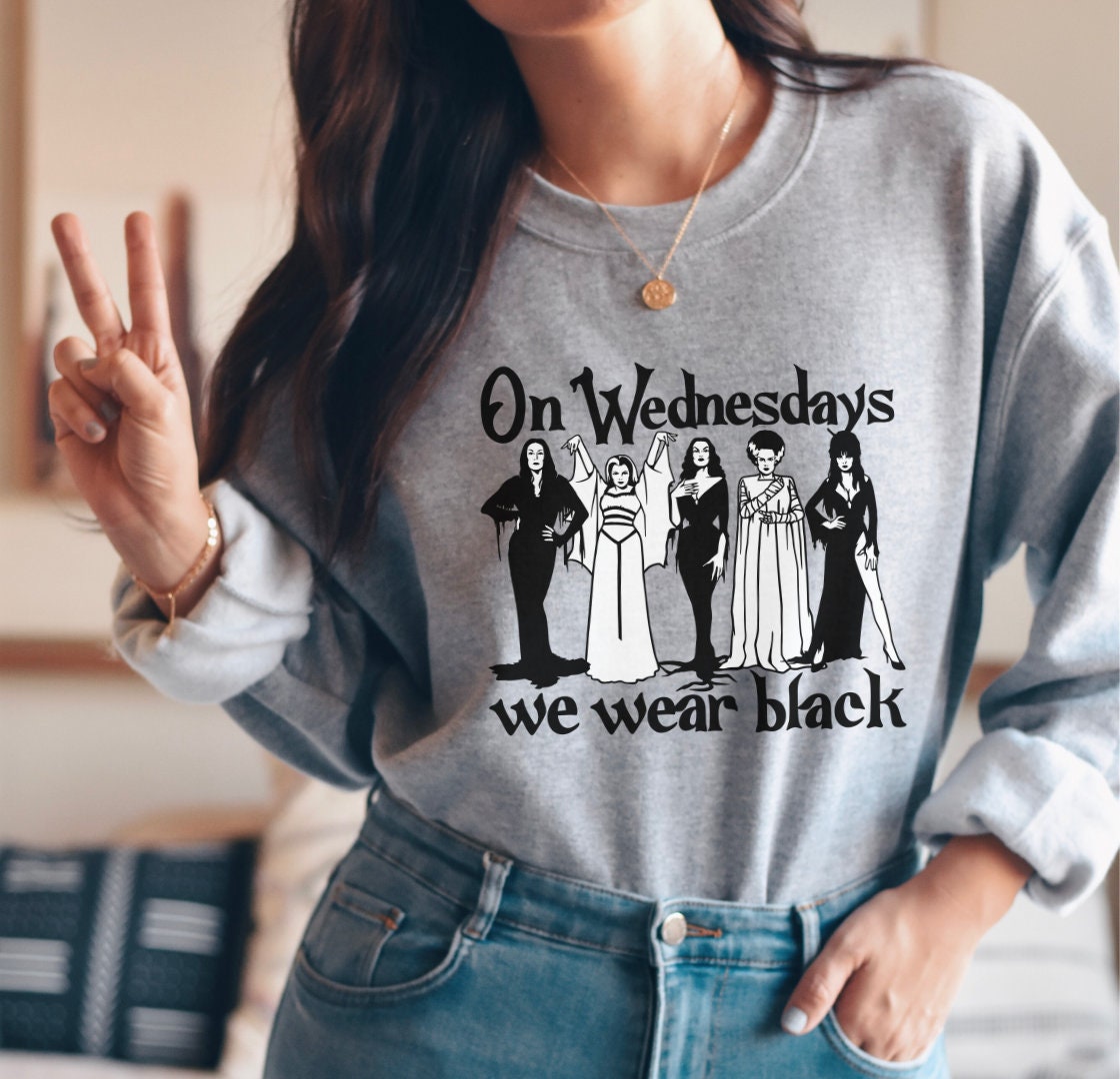 Discover On Wednesdays We Wear Black Sweatshirt, Horror Goth Queens Morticia Addams, Lily Munster, Elvira, Vampira, The Bride Sweatshirt