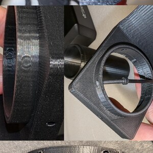 May include: Close-up of a black 3D printed object with a circular opening and a screw hole. The object has a textured surface and appears to be a part of a larger assembly.