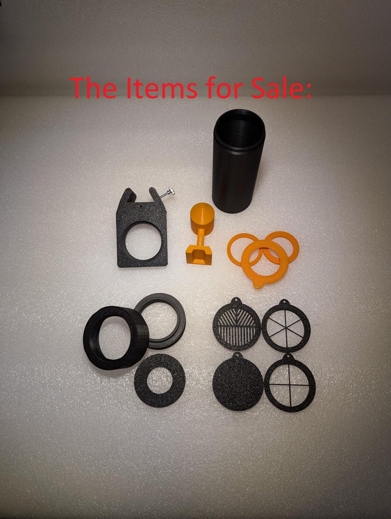 May include: A set of black plastic parts for a 3D printed project. The set includes a cylinder, a ring, a bracket, a small round piece, and several round discs with different patterns.