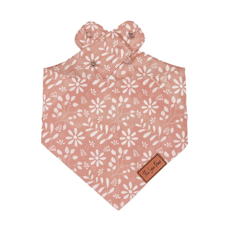 May include: A pink bandana with a white floral pattern and the text "The Luxe Pet" in the bottom right corner.