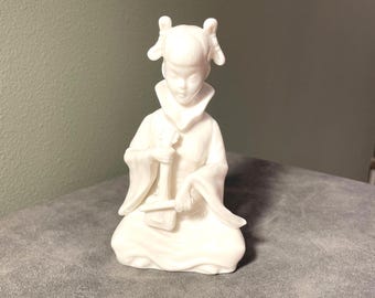White Porcelain figurine of a Chinese girl playing instrument