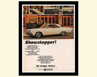 May include: A white 1965 Dodge Polara car is shown on a city street. The car is a showstopper, with a sleek design and a powerful engine. The ad text reads "Showstopper!" and "'65 Dodge Polara".