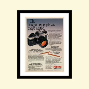 May include: A vintage advertisement for the Pentax Super Program camera. The ad features a black and silver camera with a red lens. The text reads "Oh, how some people wish they'd waited." and "Introducing the Pentax Super Program and the state of the art now."